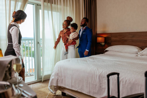 A concierge showcasing to a family a luxurious short-let apartment. gettyimages.com